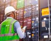 Man wearing InterSend hi-vis in warehouse checking product