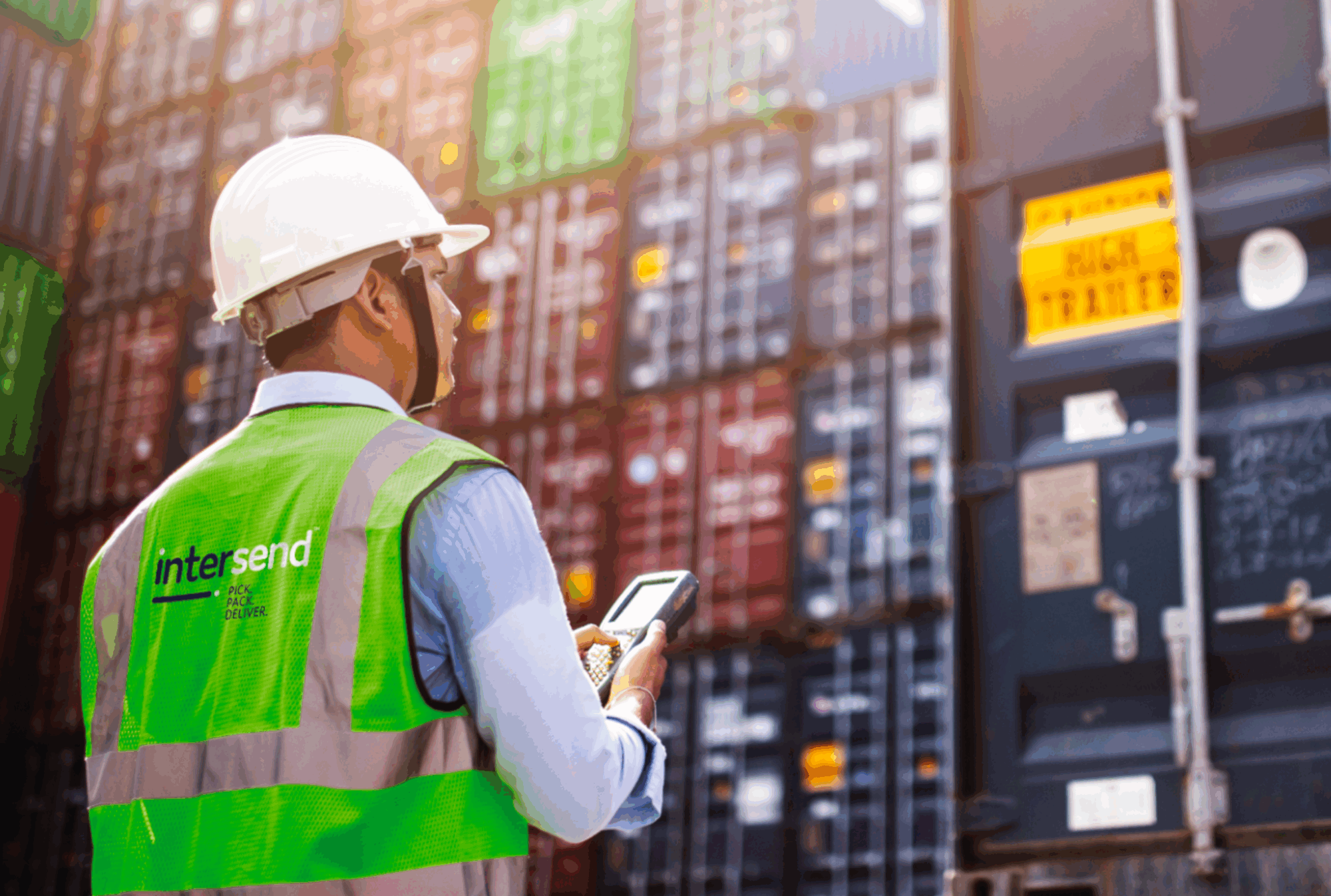 Man wearing InterSend hi-vis in warehouse checking product