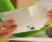 Woman opening an InterSend branded envelope