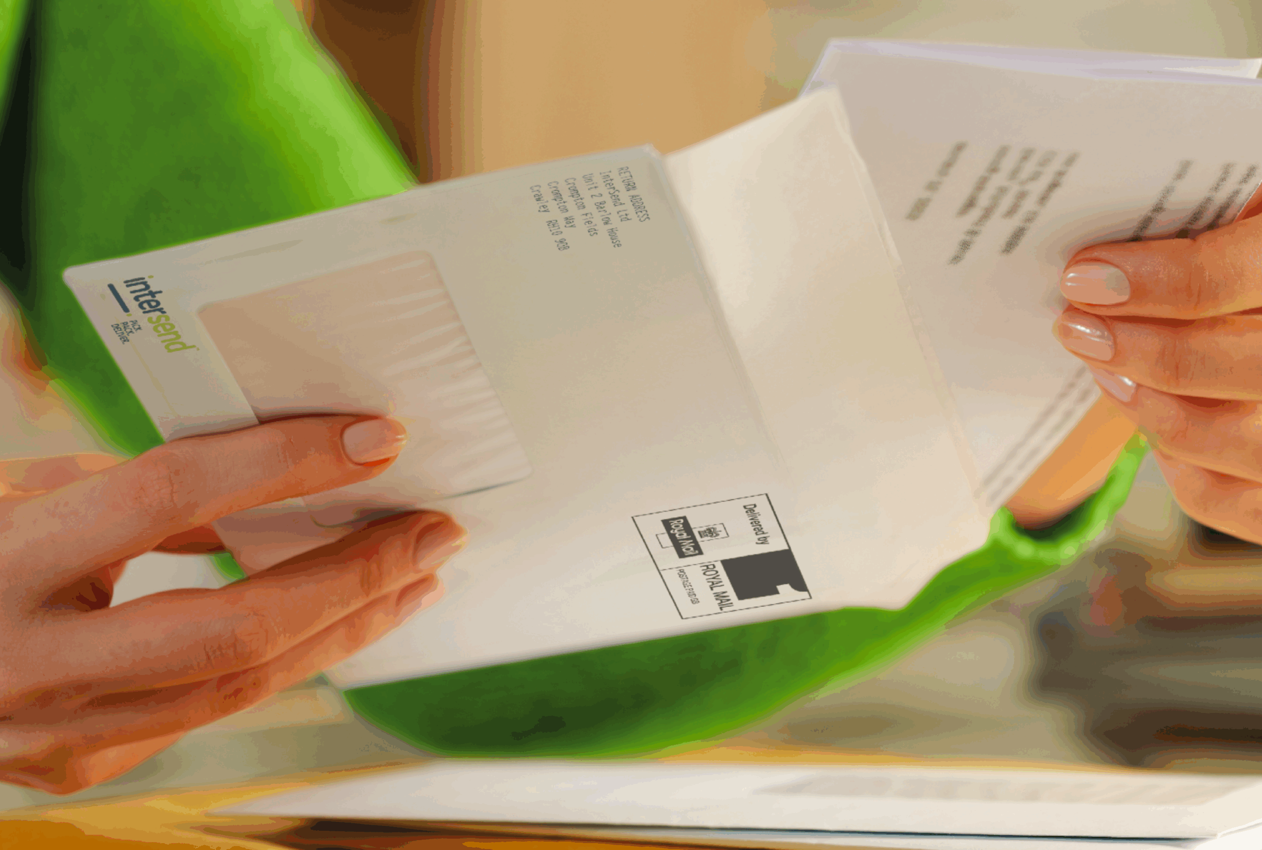 Woman opening an InterSend branded envelope