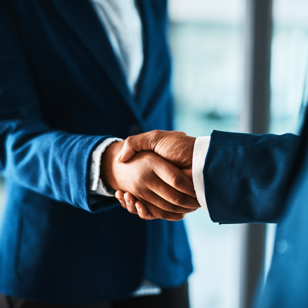 two businessmen shaking hands on a deal