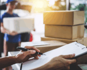 signing for post with boxes and paper