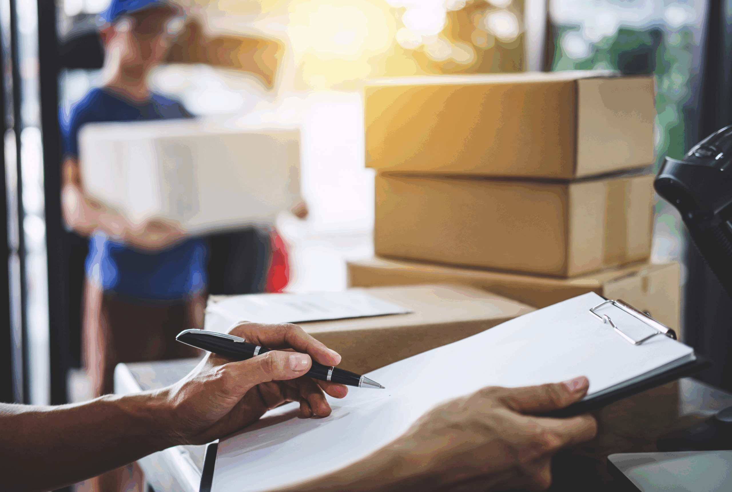 signing for post with boxes and paper
