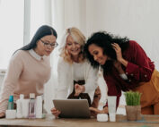 Three women buying beauty products online while spending time together