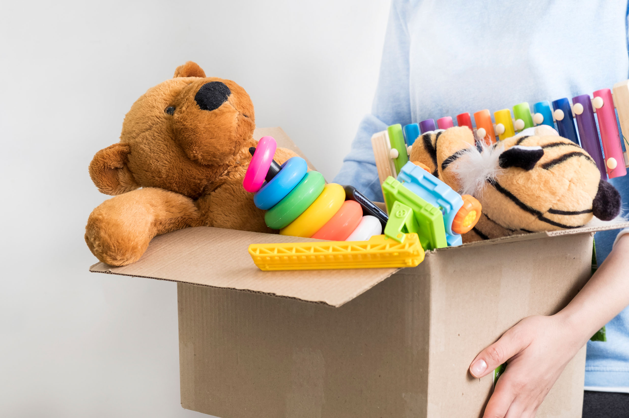 Toy packing Toys overflowing from cardboard box.